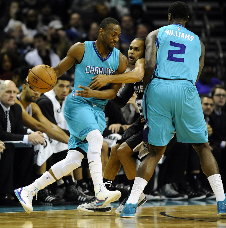 Jan. 14, 2015 - Charlotte, NC, USA - The Charlotte Hornets' Kemba Walker (15) tries to eludethe San Antonio Spurs' Patty Mills (8) by using a Marvin Williams (2) screen in the first half at Time Warner Cable Arena in Charlotte, N.C., on Wednesday, Jan. 14, 2015. San Antonio won, 98-93