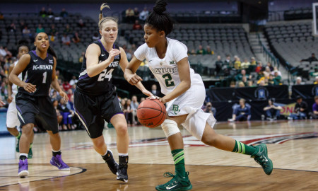 07 MAR 2015: Baylor Bears guard Niya Johnson (2) moves the ball past a defending Kansas State Wildcats guard Kindred Wesemann (24) during the NCAA Big 12 Women's basketball tournament game between the Baylor Bears and the Kansas State Wildcats at the American Airlines Center in Dallas, Texas.