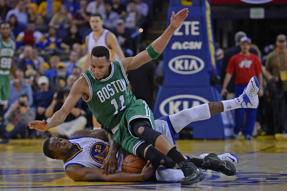 Jan. 25, 2015 - Oakland, CA, USA - The Boston Celtics' Evan Turner (11) lands on the Golden State Warriors' Draymond Green (23) while chasing down a loose ball in the fourth quarter at Oracle Arena in Oakland, Calif., on Sunday, Jan. 25, 2015. The Warriors won, 114-111, for their 19th victory in a row at home