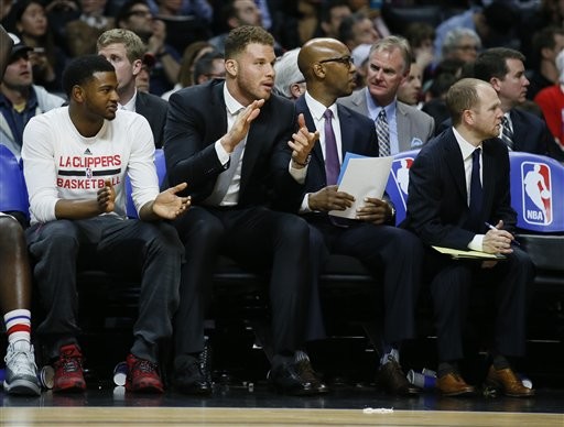 Los Angeles Clippers' Blake Griffin, left, sits on the bench with assistant coach Sam Cassell, right, during the second half of an NBA basketball game, Wednesday, Jan. 13, 2016, in Los Angeles. The Clippers won 104-90. (AP Photo/Danny Moloshok)