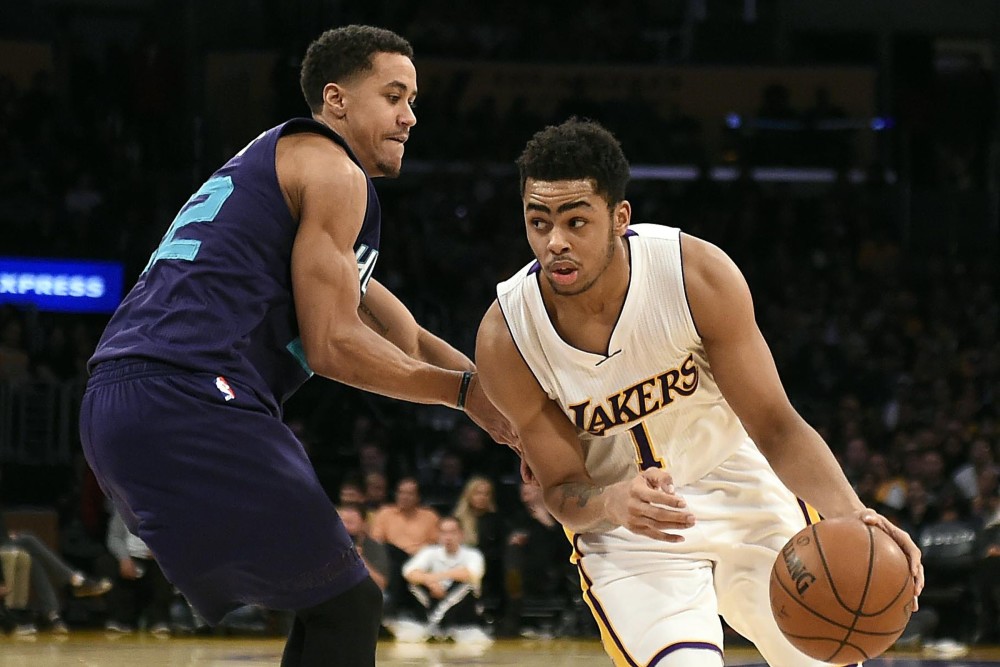Jan 31, 2016; Los Angeles, CA, USA; Los Angeles Lakers guard D'Angelo Russell (1) drives to the basket against Charlotte Hornets guard Brian Roberts (22) during the fourth quarter at Staples Center. Mandatory Credit: Richard Mackson-USA TODAY Sports