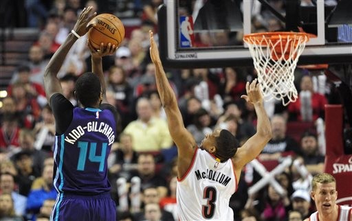 Charlotte Hornets forward Michael Kidd-Gilchrist (14) shoots over Portland Trail Blazers guard C.J. McCollum (3) during the second half of an NBA basketball game in Portland, Ore., Friday, Jan. 29, 2016. The Blazers won 109-91. (AP Photo/Steve Dykes)