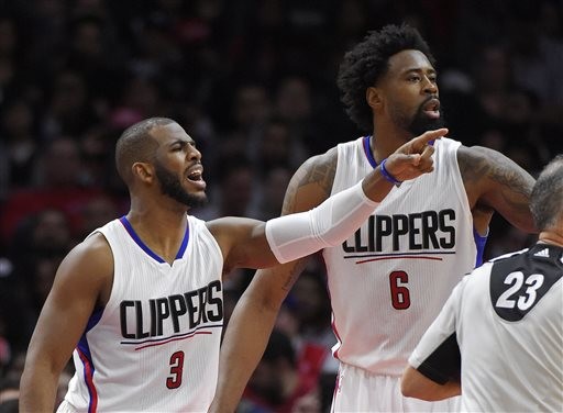 Los Angeles Clippers guard Chris Paul, left, gestures to other teammates along with center DeAndre Jordan during the second half of an NBA basketball game against the Chicago Bulls, Sunday, Jan. 31, 2016, in Los Angeles. The Clippers won 120-93. (AP Photo/Mark J. Terrill)