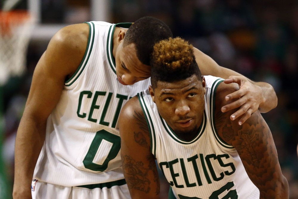 Jan 22, 2016; Boston, MA, USA; Boston Celtics guard Avery Bradley (0) and guard Marcus Smart (36) embrace during the second half of a game against the Chicago Bulls at TD Garden. Mandatory Credit: Mark L. Baer-USA TODAY Sports