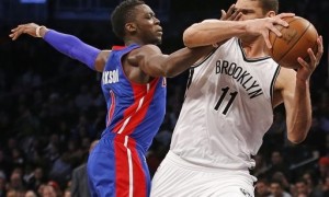 Detroit Pistons guard Reggie Jackson (1) defends Brooklyn Nets center Brook Lopez (11) with a hand in his face in the second half of an NBA basketball game, Monday, Feb. 1, 2016, in New York. The Pistons defeated the Nets 105-100. (AP Photo/Kathy Willens)
