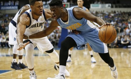 Dallas Mavericks guard Justin Anderson, left, defends as Denver Nuggets guard Emmanuel Mudiay, right, looks for an opening to the basket in the first half of an NBA preseason basketball game Tuesday, Oct. 6, 2015, in Dallas. (AP Photo/Tony Gutierrez) The Associated Press