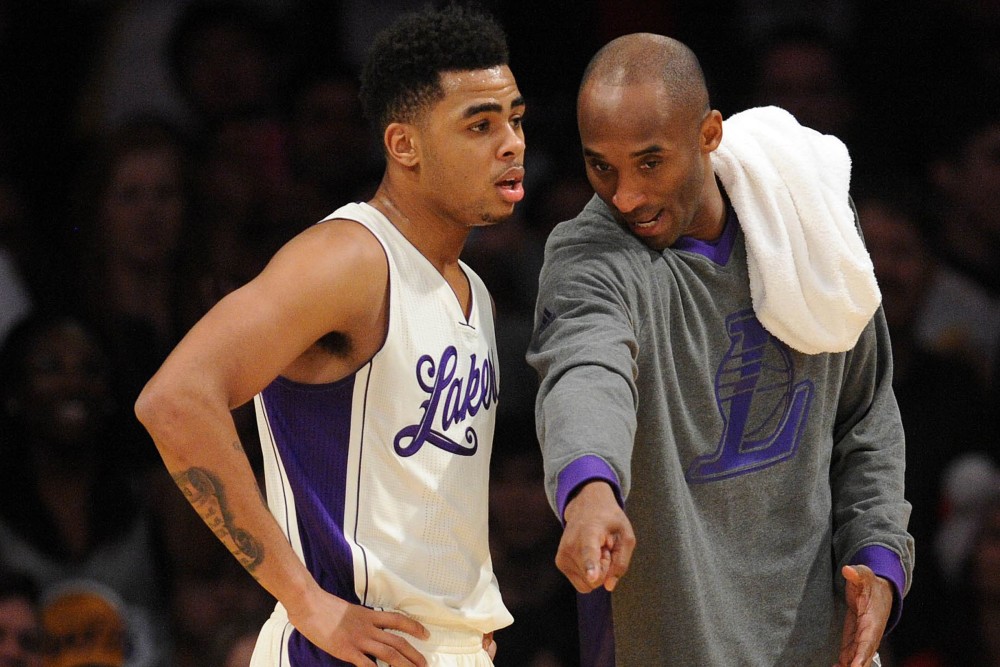 December 25, 2015; Los Angeles, CA, USA; Los Angeles Lakers forward Kobe Bryant (24) speaks with guard D'Angelo Russell (1) during a stoppage in play against Los Angeles Clippers during the second half of an NBA basketball game on Christmas at Staples Center. Mandatory Credit: Gary A. Vasquez-USA TODAY Sports