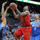 Jan. 18, 2016 - Atlanta, GA, USA - Atlanta Hawks guard Jeff Teague drives to the basket for two points past Orlando Magic defenders Evan Fournier, left, and Channing Frye on Monday, Jan. 18, 2016, at Philips Arena in Atlanta (Photo by Curtis Compton/Zuma Press/Icon Sportswire)