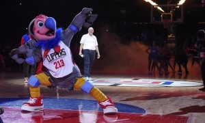 New Clippers mascot Chuck the Condor flexes as team owner Steve Ballmer stands in the background during halftime of a game on Feb. 29. (Mark J. Terrill / Associated Press
