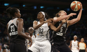 New York Liberty's Swin Cash, center, battles for a rebound with San Antonio Stars' Sophia Young-Malcolm, left, and Dearica Hamby during the second half of the WNBA basketball game, Wednesday, July 15, 2015, in New York. The Liberty defeated the Stars 84-68. (AP Photo/Seth Wenig)
