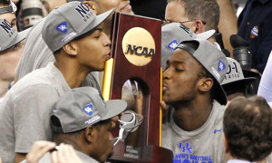Kentucky forward Anthony Davis, left, and forward Michael Kidd-Gilchrist, right, kiss the trophy after the NCAA Final Four tournament college basketball championship game Tuesday, April 3, 2012, in New Orleans. Kentucky beat Kansas 67-59. (AP Photo/Bill Haber)