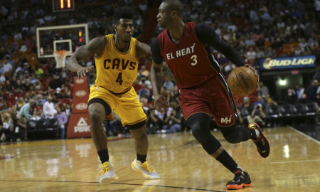 Miami Heat guard Dwyane Wade (3) moves the ball down the court as Cleveland Cavaliers guard Iman Shumpert (4) defends during the second half of an NBA basketball game, Saturday, March 19, 2016, in Miami. (AP Photo/Lynne Sladky)