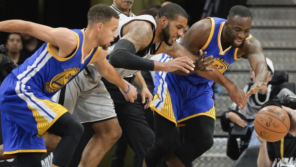 San Antonio Spurs forward LaMarcus Aldridge, center, chases the ball against Golden State Warriors' Stephen Curry (30) and Draymond Green Saturday, March 19, 2016, in San Antonio. (AP Photo/Darren Abate)