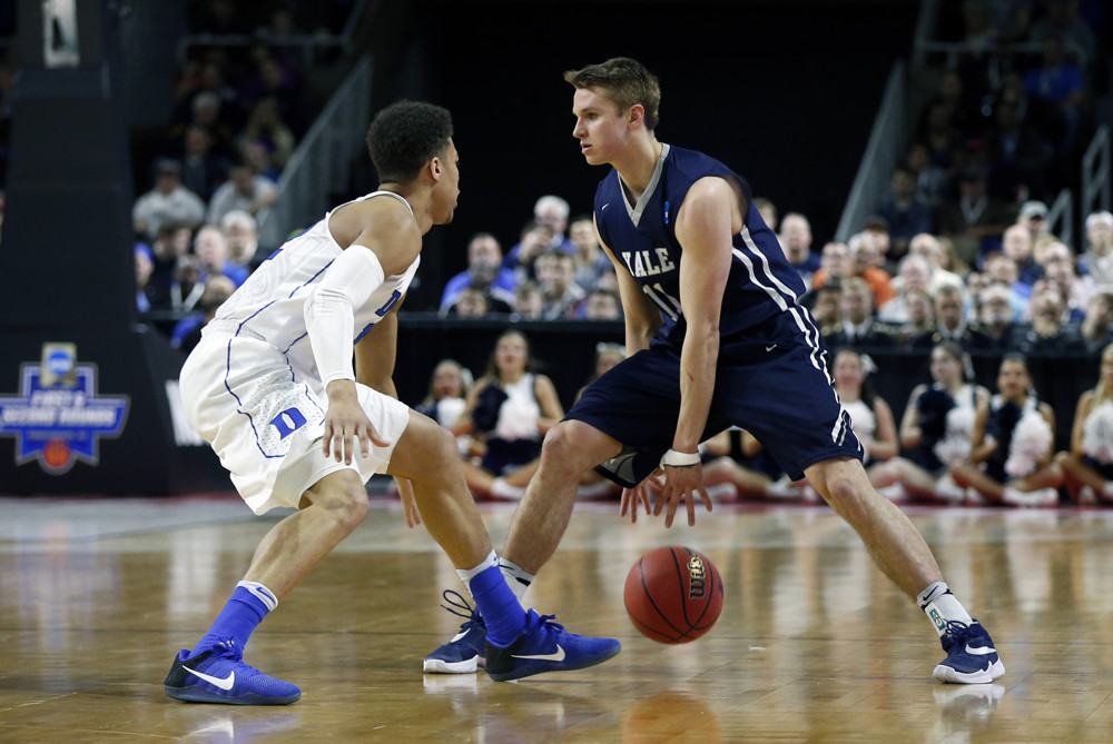19 March 2016: G Makai Mason (11) of the Yale Bulldogs cross over dribbles looking for a way past G Derryck Thornton (12) of the Duke Blue Devils. The Duke Blue Devils defeated the Yale Bulldogs 71-64 in the second round of the NCAA Division 1 men's basketball tournament at the Dunkin Donuts Center in Providence Rhode Island. (Photograph by Fred Kfoury III/Icon Sportswire)