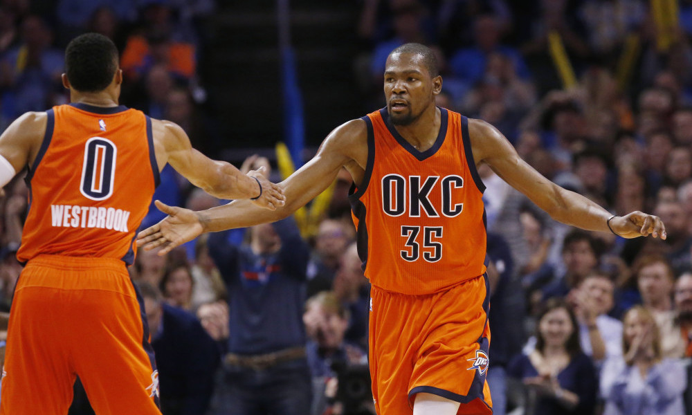 Oklahoma City Thunder forward Kevin Durant (35) slaps hands with Russell Westbrook (0) following a basket during the third quarter of an NBA basketball game against the Memphis Grizzlies in Oklahoma City, Wednesday, Jan. 6, 2016. Oklahoma City won 112-94. (AP Photo/Sue Ogrocki)