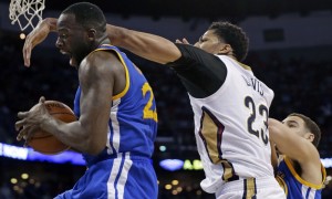 Golden State Warriors forward Draymond Green pulls down a rebound in front of New Orleans Pelicans forward Anthony Davis (23) in the second half of an NBA basketball game in New Orleans, Tuesday, April 7, 2015. The Pelicans won 103-100. (AP Photo/Gerald Herbert)