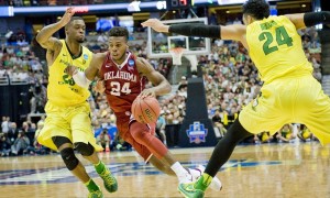 March 26, 2016 - Anaheim, CA, USA - Oklahoma guard Buddy Hield, center, drives toward the basket between Oregon forward Elgin Cook, left, and forward Dillon Brooks, right, in the NCAA West Regional Championship at the Honda Center on Saturday. (Photo by Paul Rodriguez/Zuma Press/Icon Sportswire)
