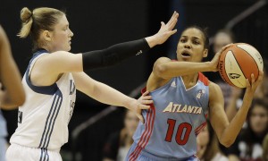 Atlanta Dream guard Lindsey Harding looks to pass around Minnesota Lynx's Lindsay Whalen, left, in the first half of an WNBA basketball game, Friday, June 17, 2011, in Minneapolis. (AP Photo/Stacy Bengs)