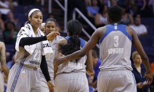 Minnesota Lynx's Maya Moore (23) celebrates a run against the Phoenix Mercury with Natasha Howard (3) and Jia Perkins, middle, during the second half of a WNBA basketball game Wednesday, May 25, 2016, in Phoenix. The Lynx defeated the Mercury 85-78. (AP Photo/Ross D. Franklin)