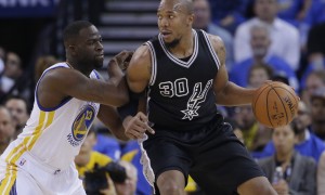 San Antonio Spurs' David West (30) is defended by Golden State Warriors' Draymond Green (23) during the first half of an NBA basketball game Monday, Jan. 25, 2016, in Oakland, Calif. (AP Photo/Marcio Jose Sanchez)